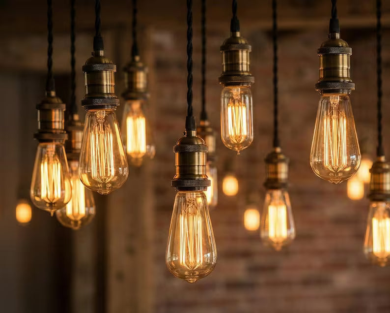 Gruppo di lampadine Edison vintage sospese con luce calda in ambiente industriale